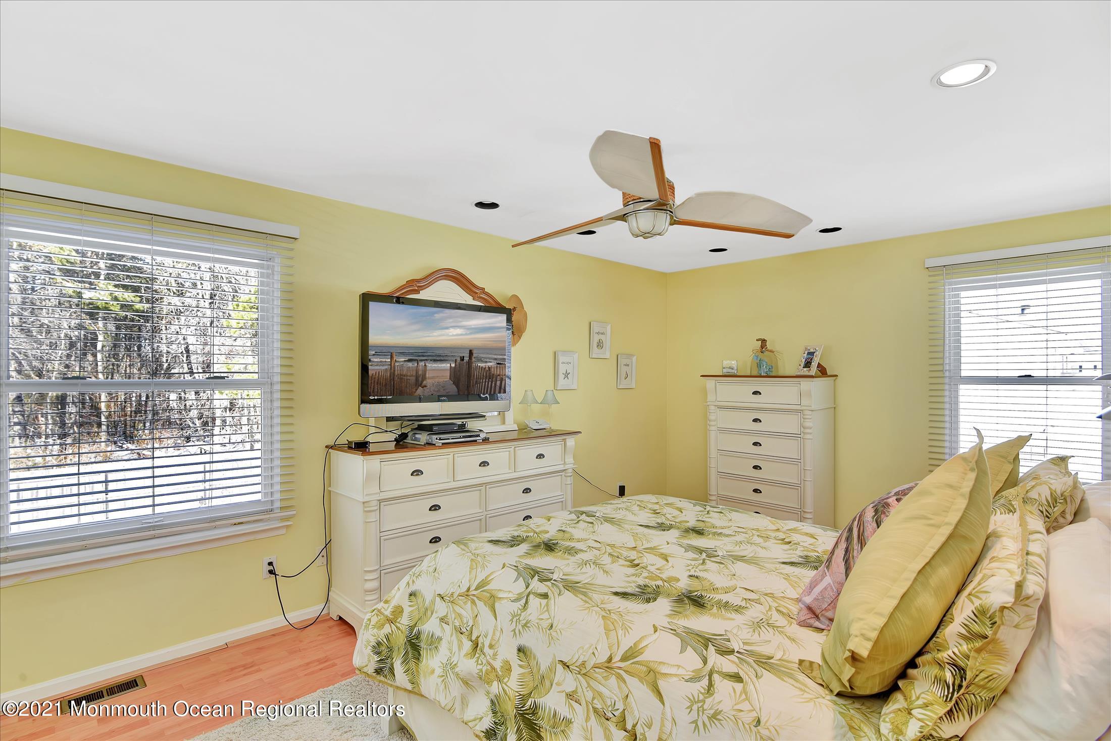 63 Hedgewood Road Howell, NJ 07731 - Photo 18 of 25 a bedroom with a bed and a flat screen tv