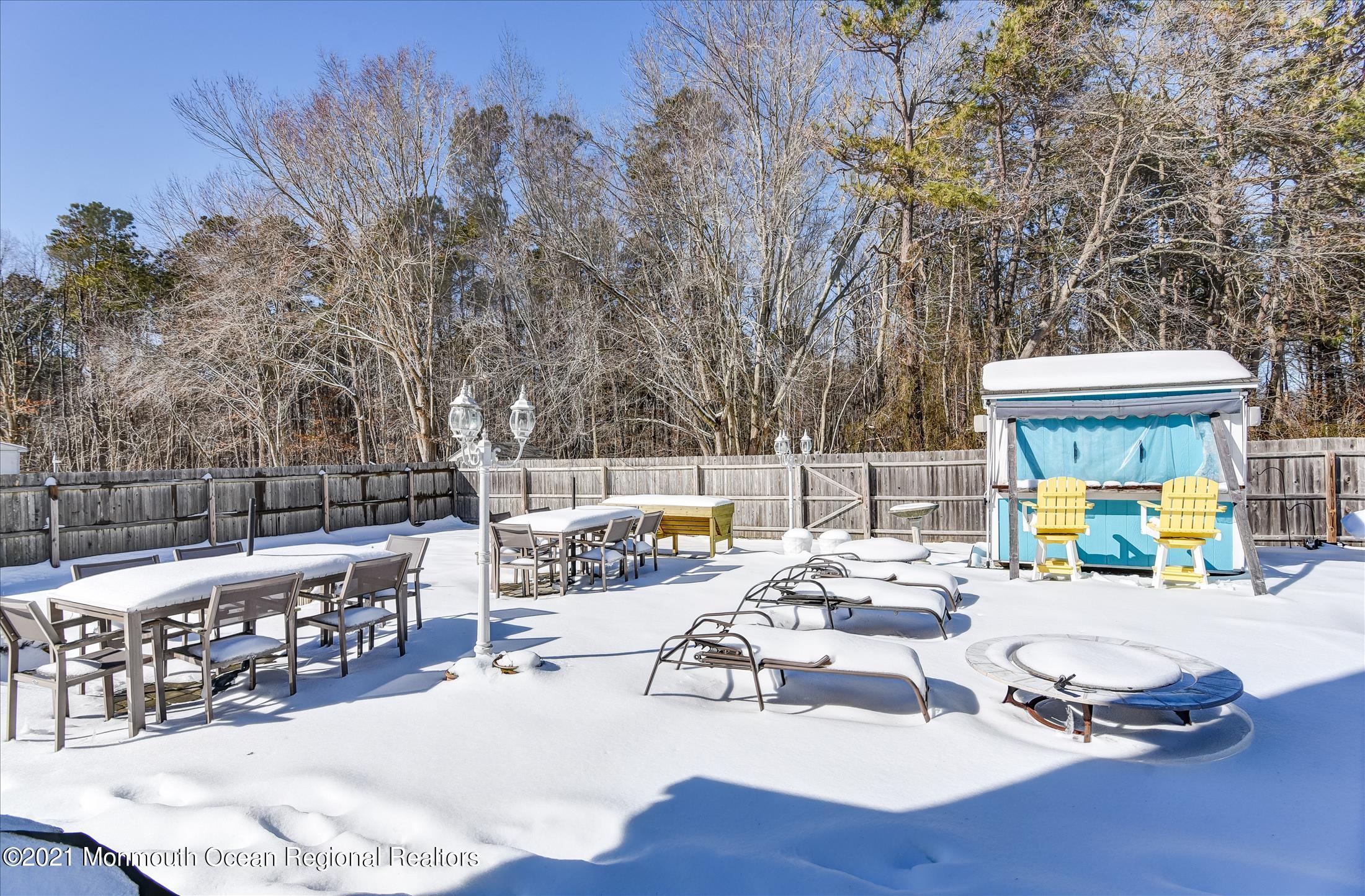 63 Hedgewood Road Howell, NJ 07731 - Photo 21 of 25 a view of a patio with couches table and chairs and wooden fence