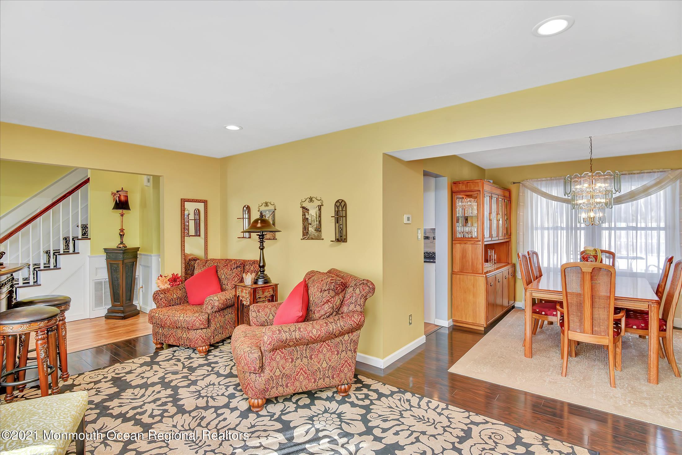 63 Hedgewood Road Howell, NJ 07731 - Photo 5 of 25 a living room with furniture a rug and a floor to ceiling window