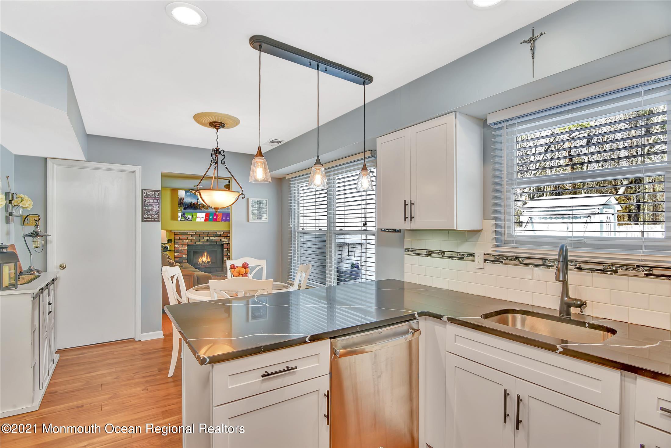 63 Hedgewood Road Howell, NJ 07731 - Photo 10 of 25 a kitchen with granite countertop a sink a counter space appliances and cabinets