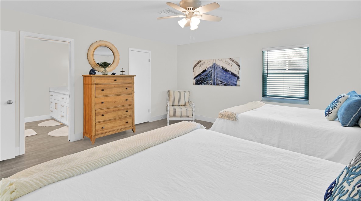 7989 143rd Street Sebastian, FL 32958 - Photo 13 of 30 a bedroom with a bed and a chandelier