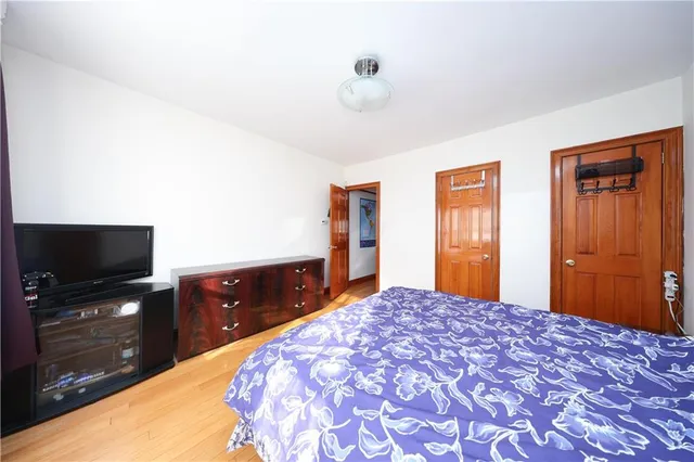 a bedroom with a bed and a dresser