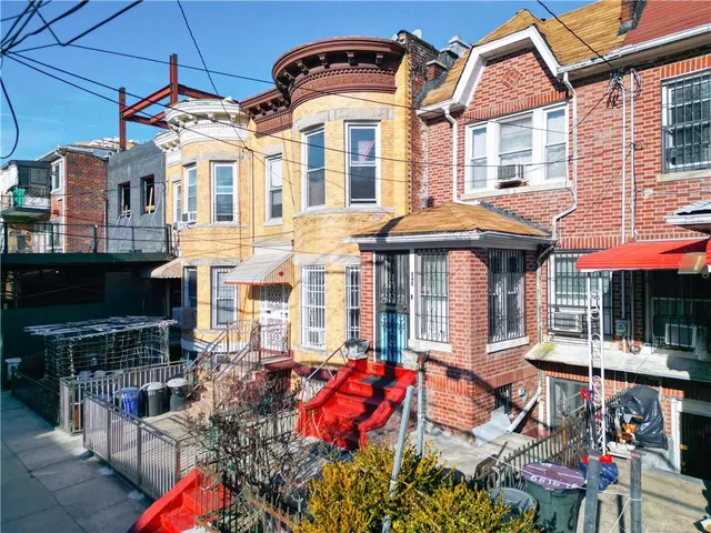 a front view of a building with outdoor seating