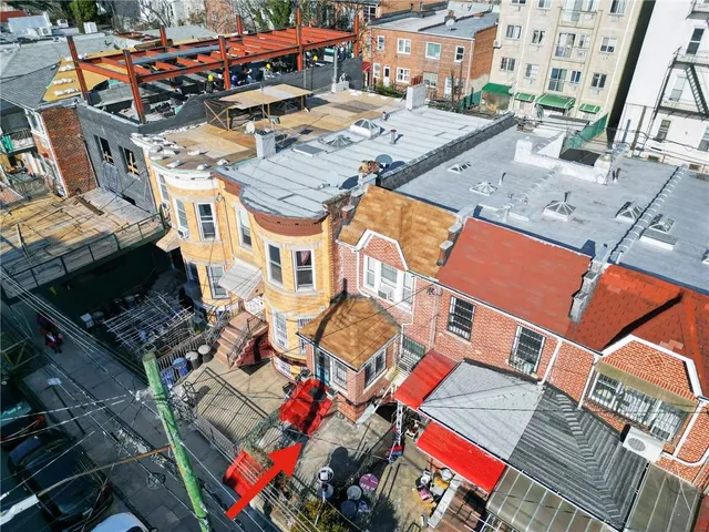 an aerial view of a house with a swimming pool
