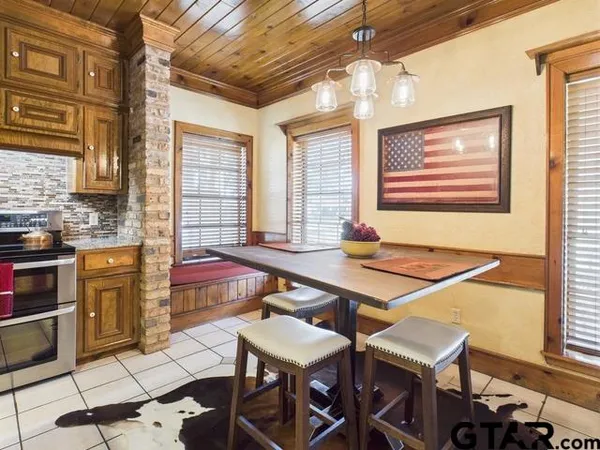 a room with furniture pool table and windows