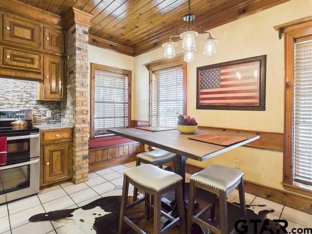 a room with furniture pool table and windows