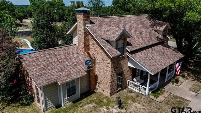 a view of a house with roof deck front of house