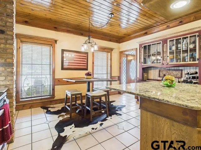 a living room with furniture and floor to ceiling windows
