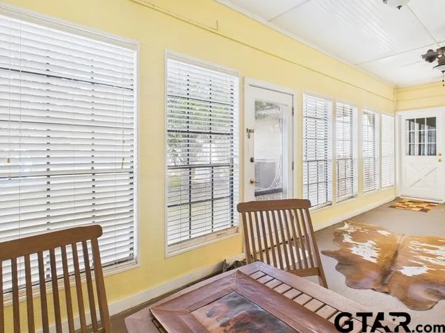 a view of a bedroom with a bed and wooden floor