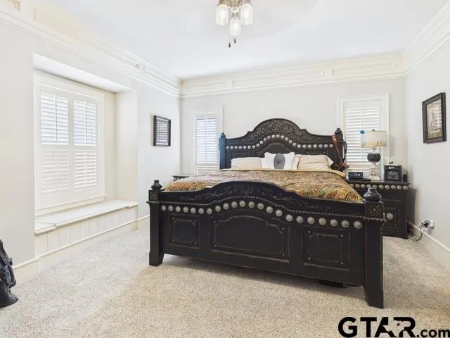 a bedroom with a bed window and a dresser