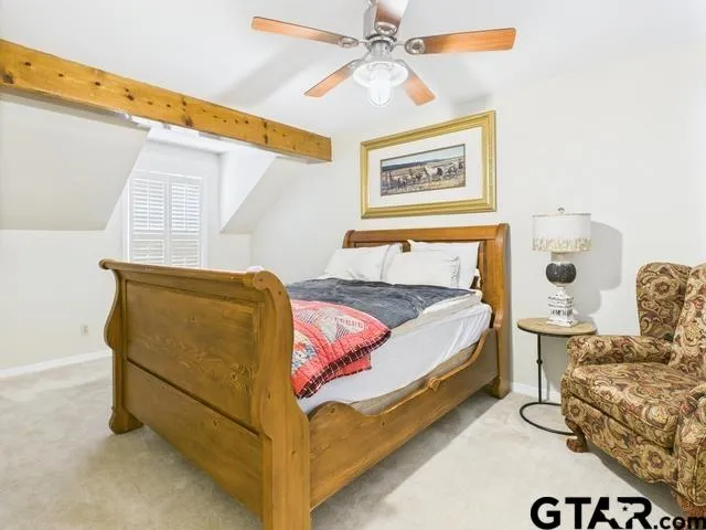 a bed sitting in a bedroom next to a window