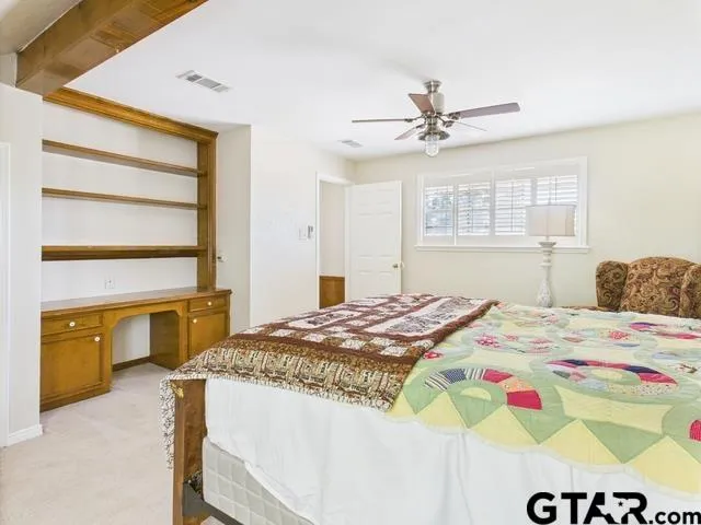 a bath room with a granite countertop sink a toilet and shower