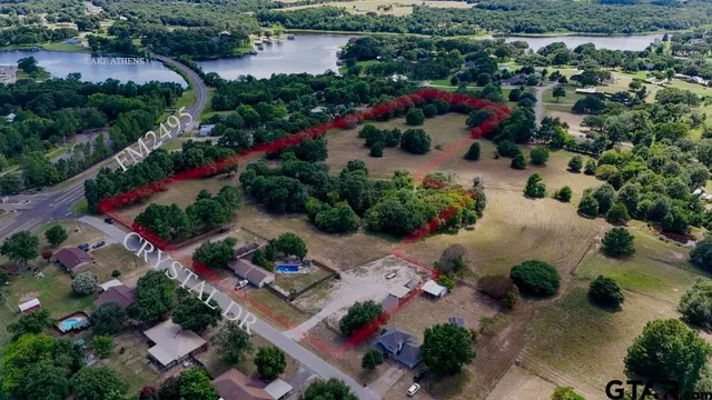 an aerial view of a house with a yard and lake view