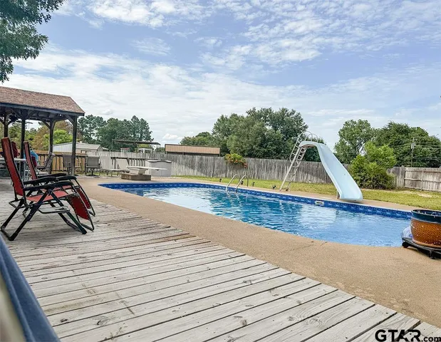an aerial view of a house with swimming pool garden and patio