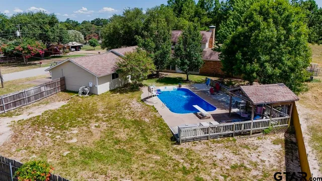 a view of a chair and table in the backyard