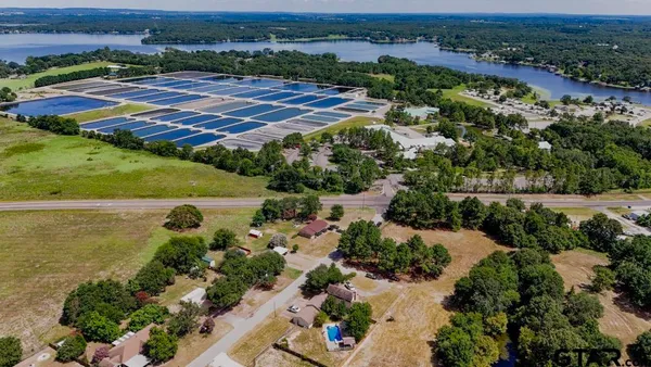 an aerial view of residential houses with outdoor space and river