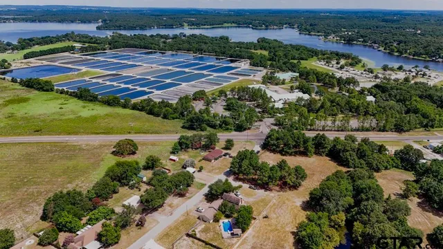 an aerial view of residential houses with outdoor space and river