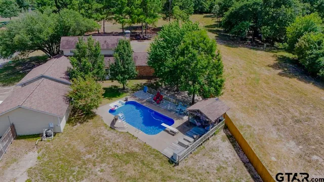 an aerial view of a house with outdoor space and street view