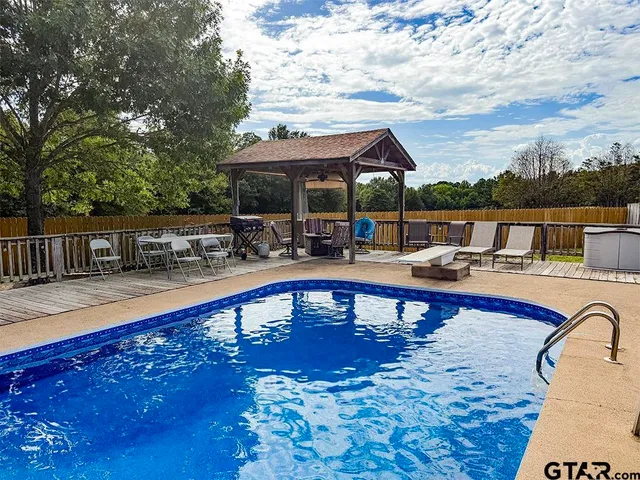 swimming pool view with a seating space