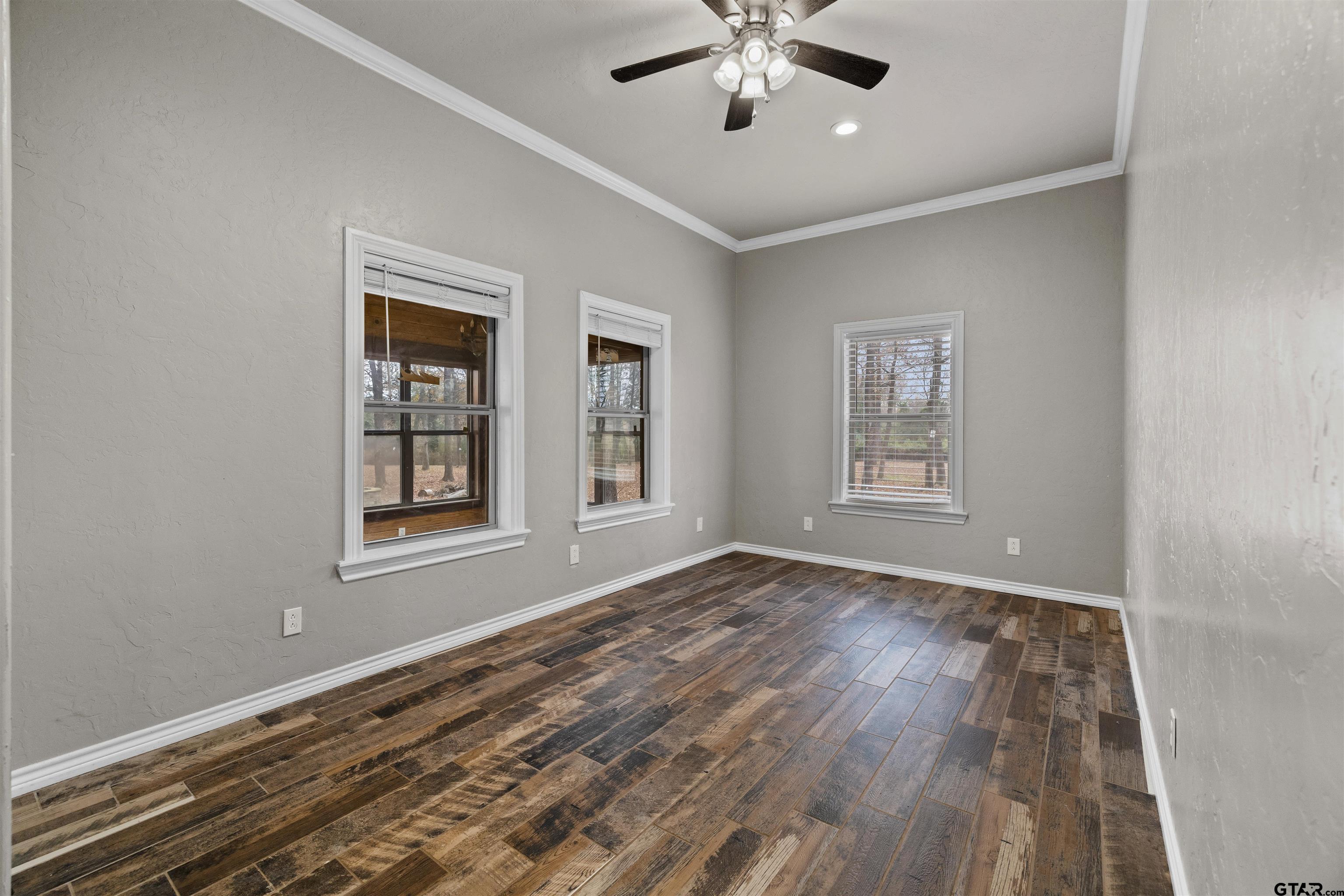 5796 Highway 271 Pittsburg, TX 75686 - Photo 16 of 43 a view of an empty room with a window and wooden floor