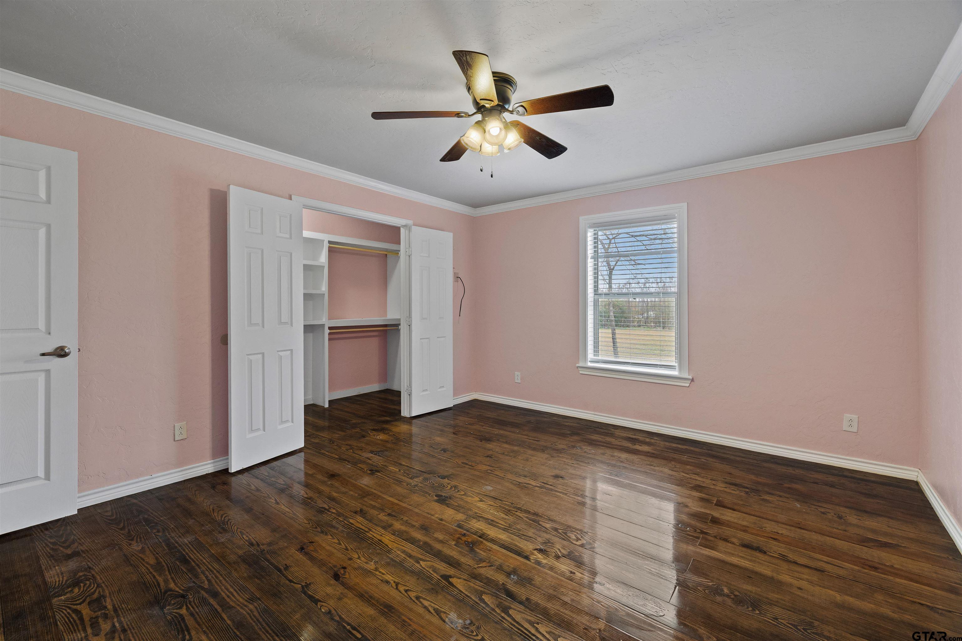 5796 Highway 271 Pittsburg, TX 75686 - Photo 28 of 43 a view of empty room with wooden floor and fan