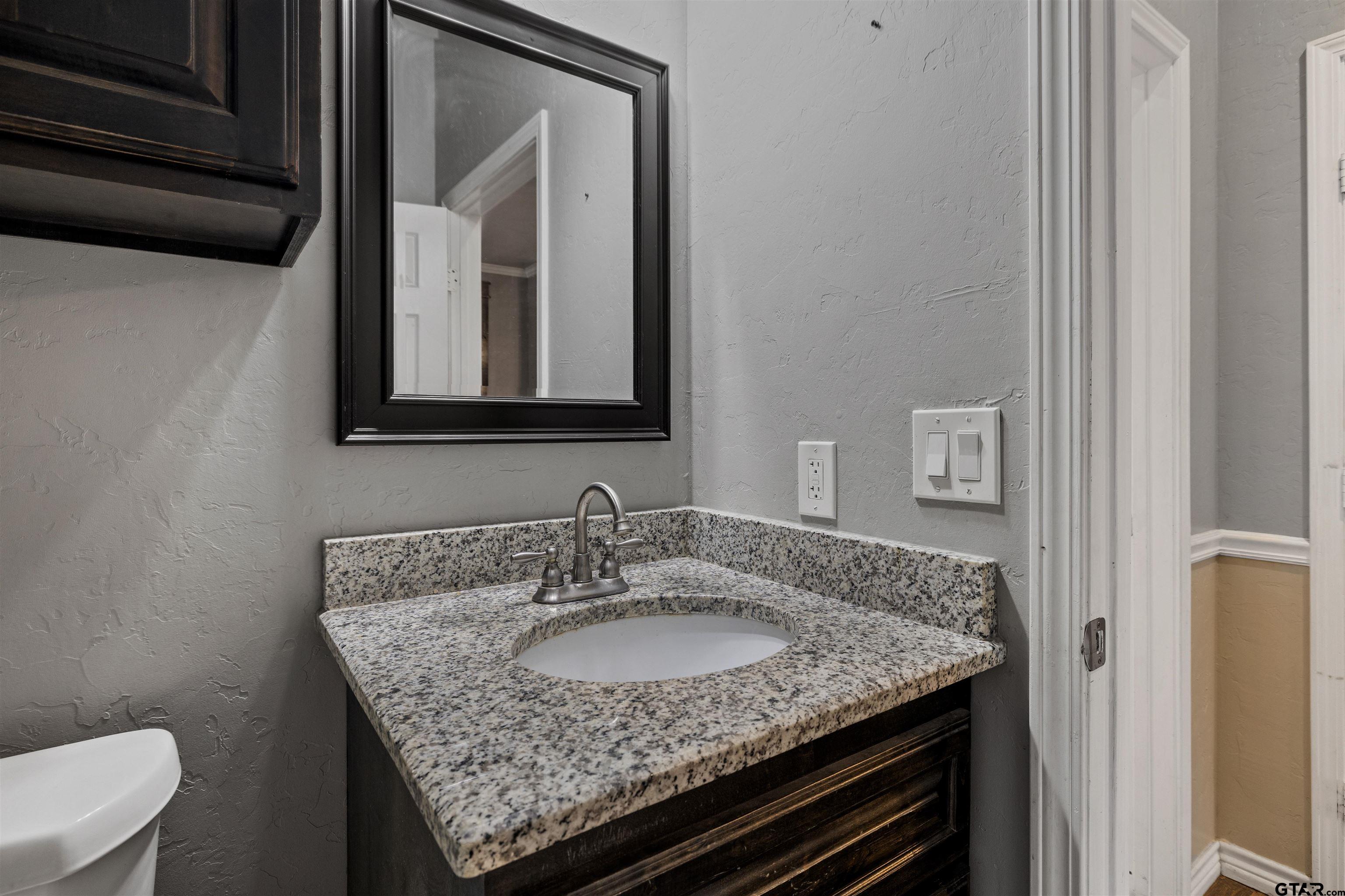 5796 Highway 271 Pittsburg, TX 75686 - Photo 29 of 43 a bathroom with a granite countertop sink and a mirror