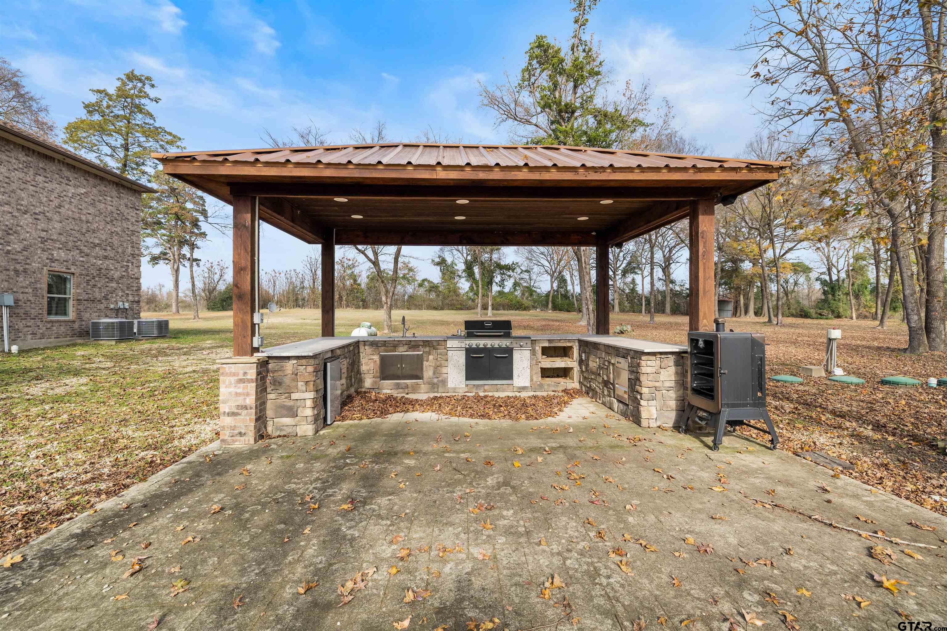 5796 Highway 271 Pittsburg, TX 75686 - Photo 36 of 43 a view of a chairs and table in patio with a backyard