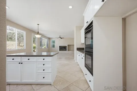 a kitchen with granite countertop a stove and a sink