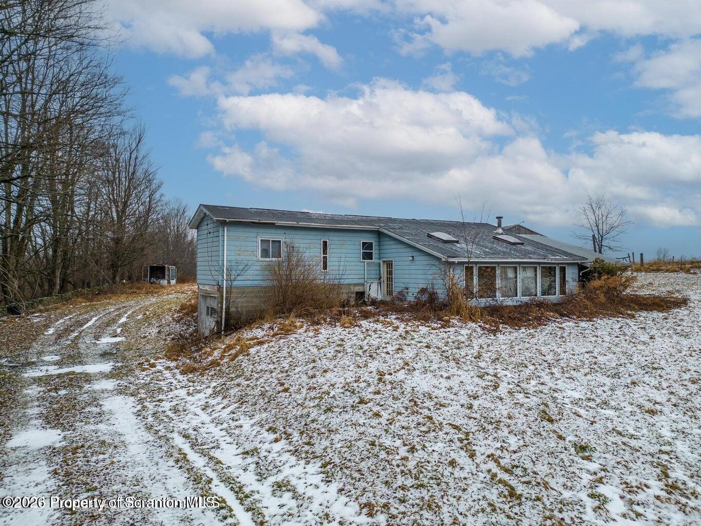 1777 Lamb Road Thompson, PA 18465 - Photo 2 of 31 a front view of a house with a yard