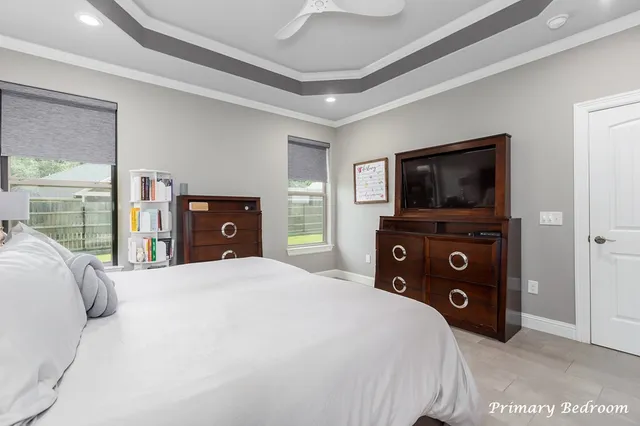 a bedroom with a bed and a television