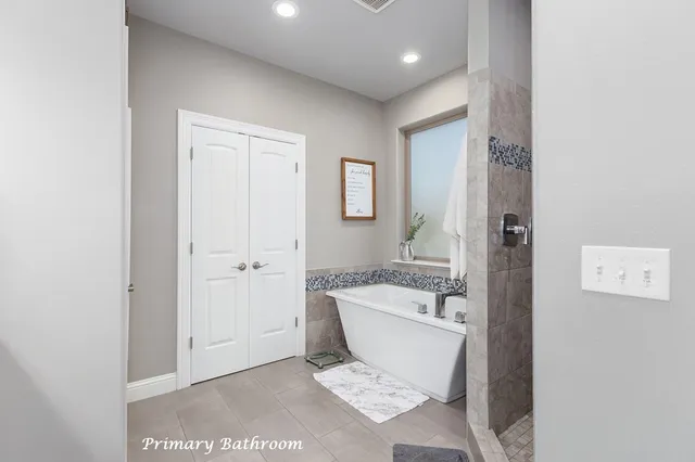 a spacious bathroom with a bathtub and shower