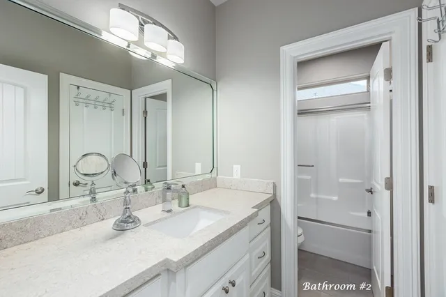 a bathroom with a double vanity sink and a mirror