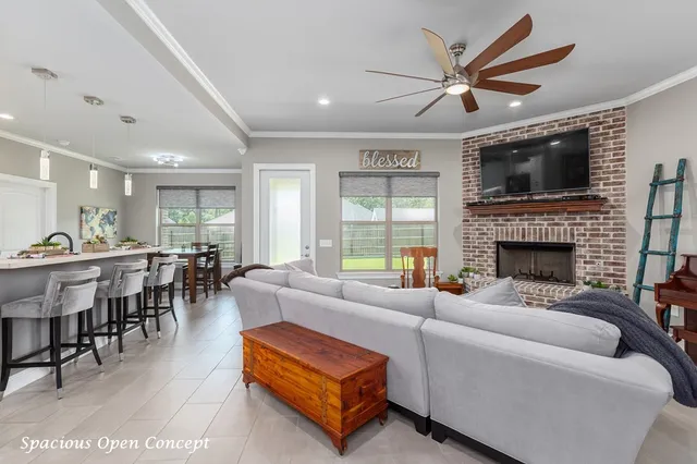 a living room with furniture kitchen view and a fireplace