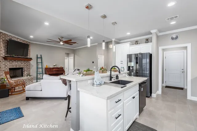 a view of kitchen with sink refrigerator and microwave