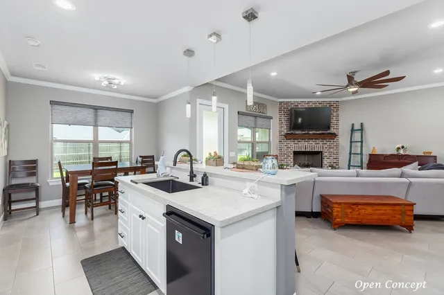 a kitchen with sink refrigerator and cabinets