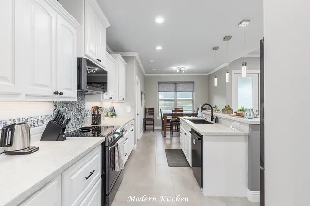 a kitchen with lots of counter top space a sink and appliances