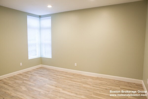 10 Roxbury Street, Unit 10 Boston, MA 02119 - Photo 3 of 8 a view of empty room with wooden floor