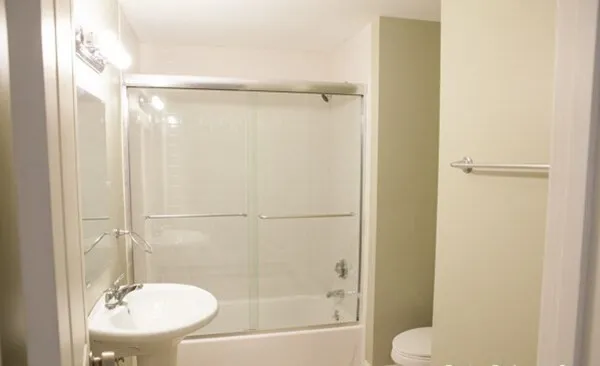 a bathroom with a shower and a toilet