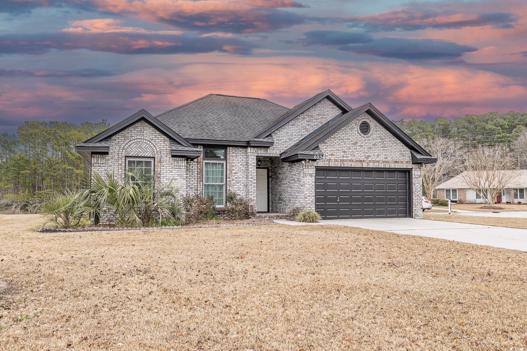 603 Hatteras River Road Myrtle Beach, SC 29588 - Photo 1 of 22 View of front of home featuring a garage and a yar
