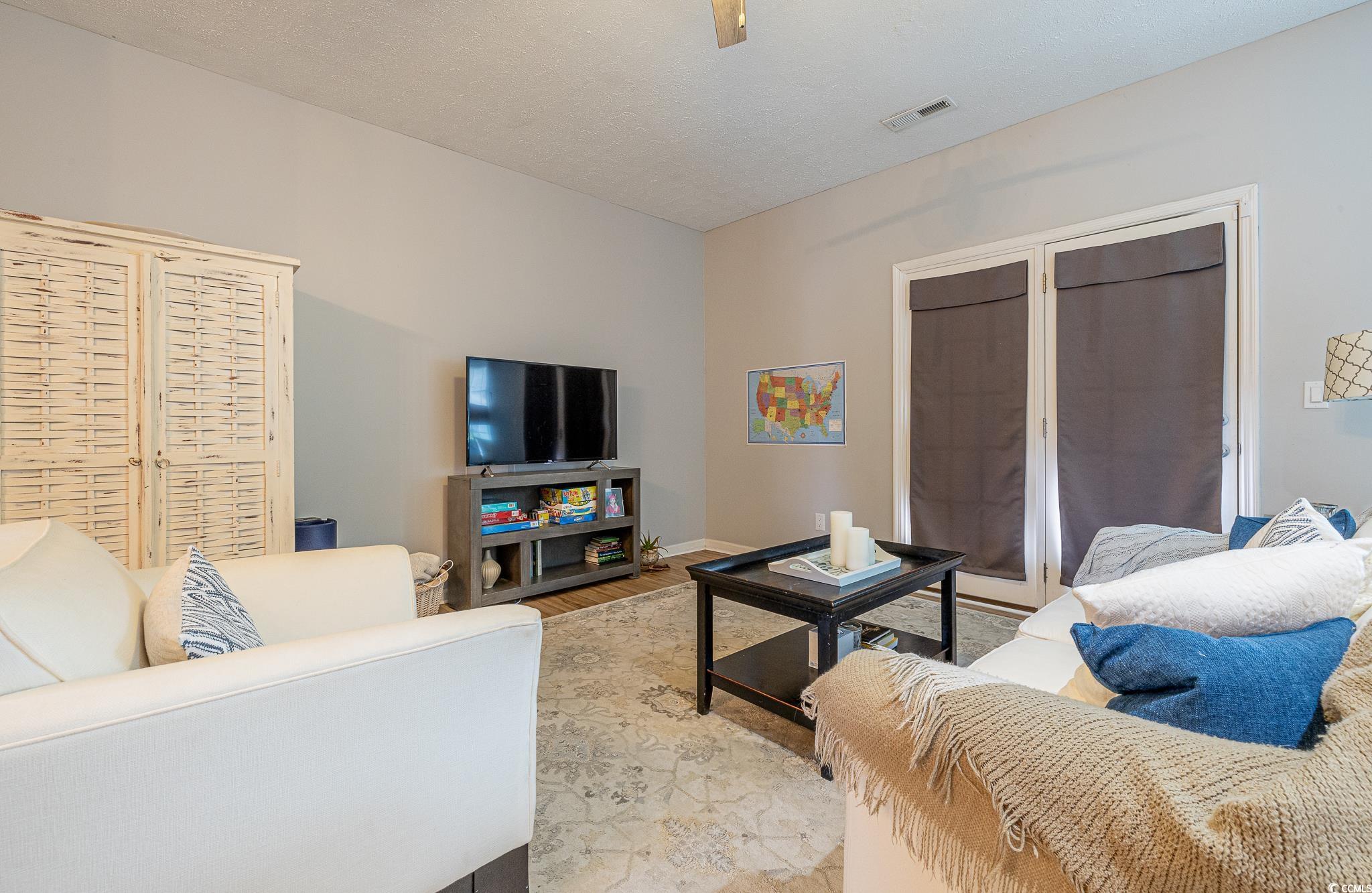 603 Hatteras River Road Myrtle Beach, SC 29588 - Photo 11 of 22 Living room featuring a textured ceiling and light