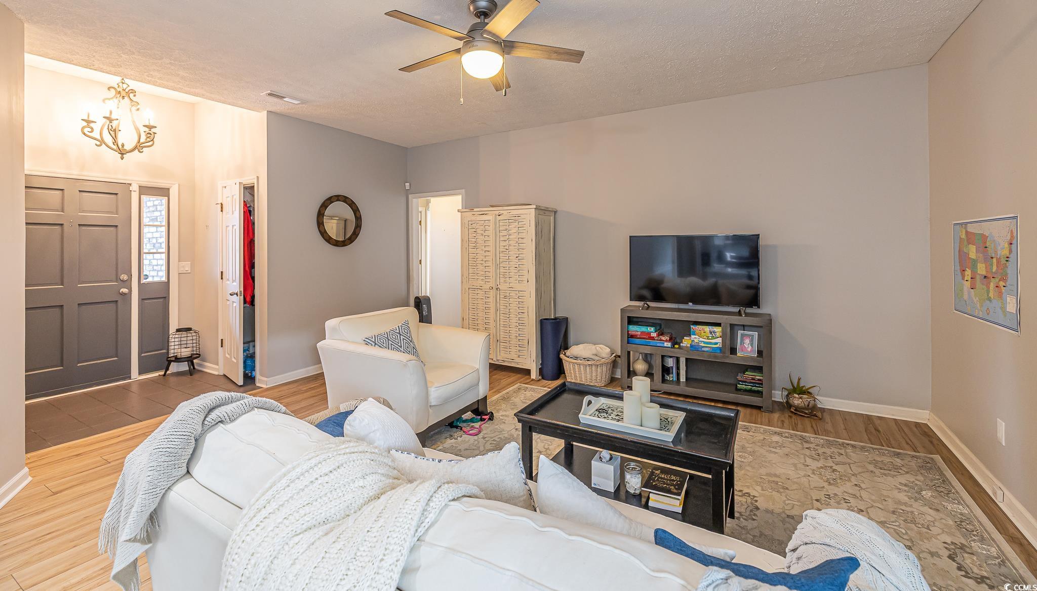 603 Hatteras River Road Myrtle Beach, SC 29588 - Photo 6 of 22 Living room with a textured ceiling, ceiling fan w