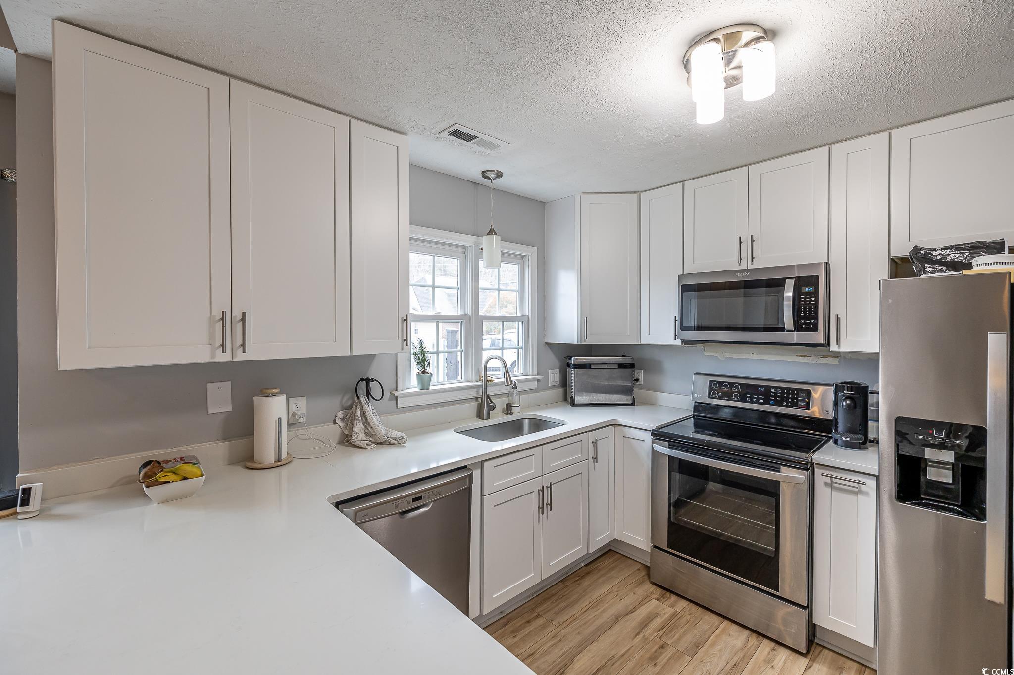 603 Hatteras River Road Myrtle Beach, SC 29588 - Photo 9 of 22 Kitchen with light hardwood / wood-style floors, s