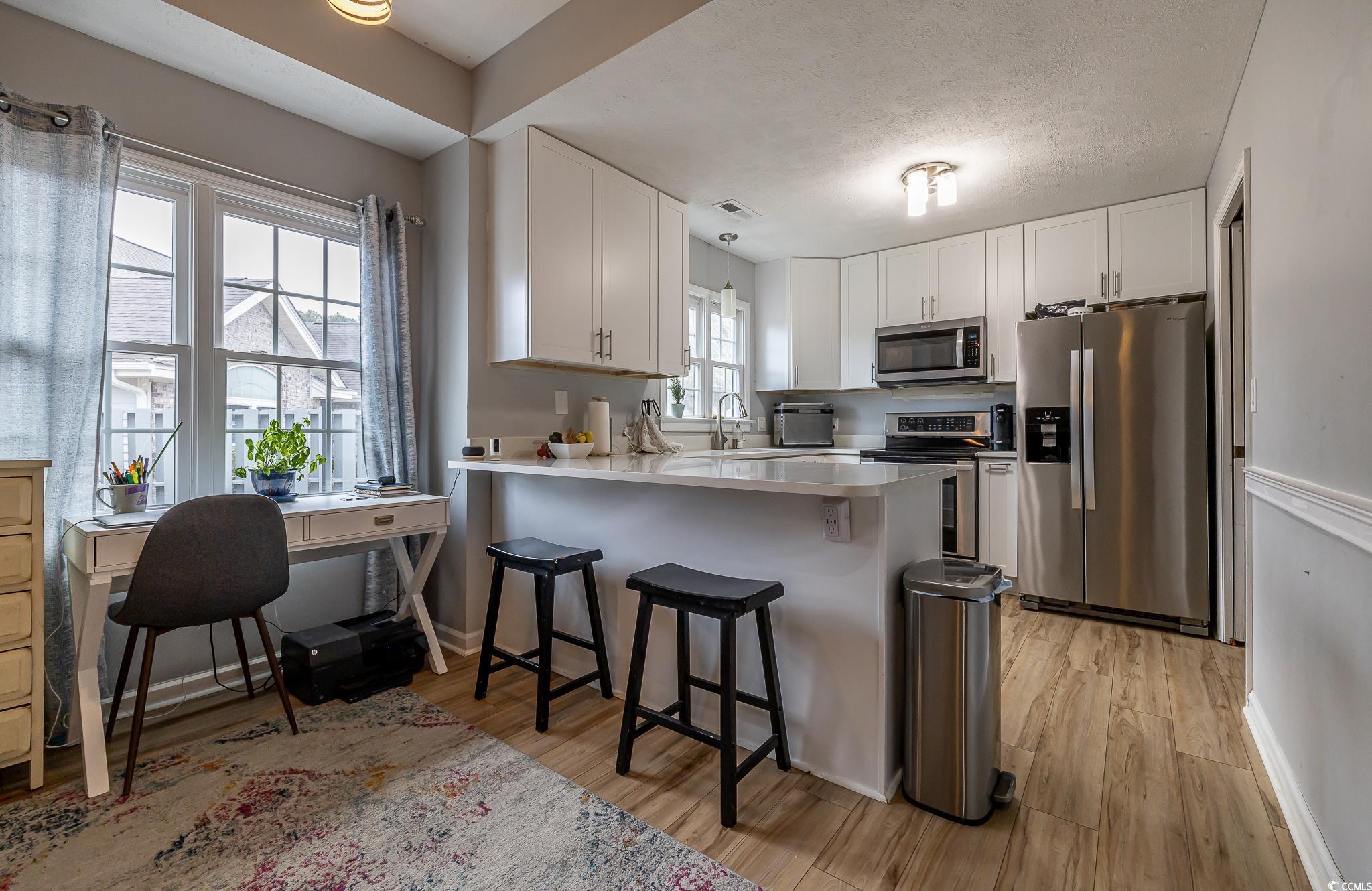 603 Hatteras River Road Myrtle Beach, SC 29588 - Photo 10 of 22 Kitchen featuring kitchen peninsula, appliances wi