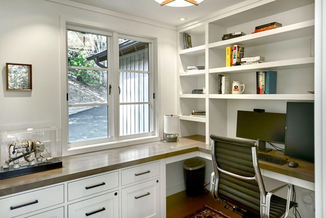 a room with a large window and shelf