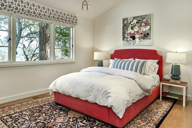 a bed sitting in a bedroom next to a window