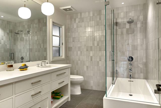 a bathroom with a sink double vanity granite toilet and shower