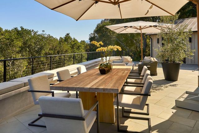 a view of a tables and chairs under an umbrella