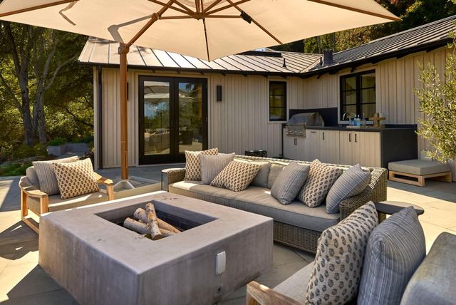 a view of a patio with couches and a table and chairs