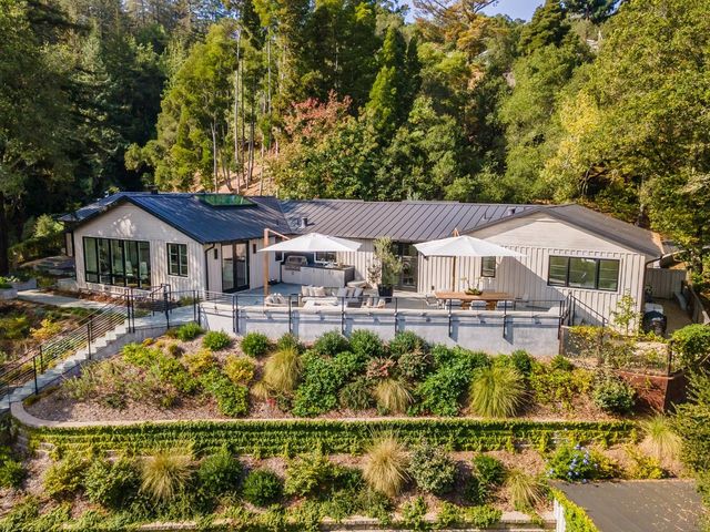 a front view of a house with swimming pool having outdoor seating
