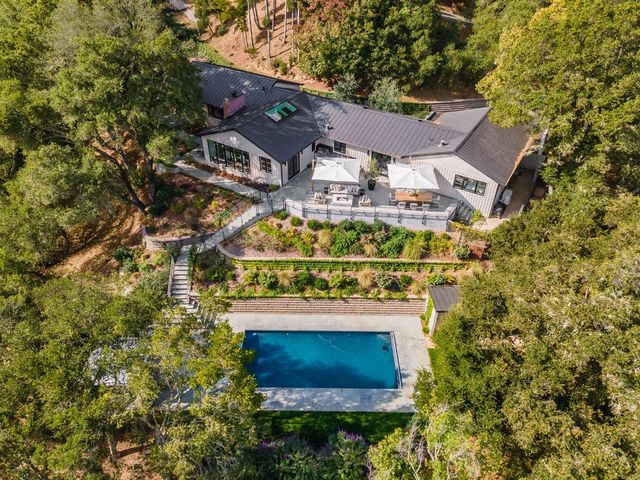 an aerial view of a house with a yard and garden